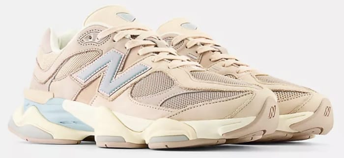 View of tan and blue New Balance shoes.